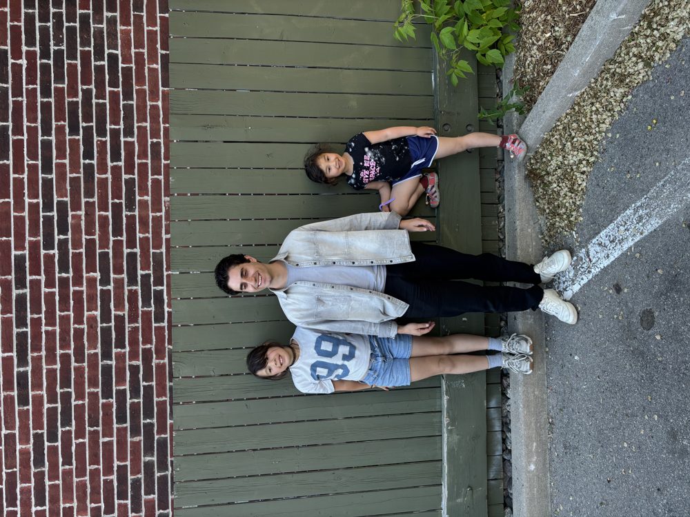 David with the kids by the green fence